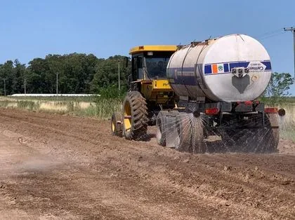 Watering truck adding the product to the water